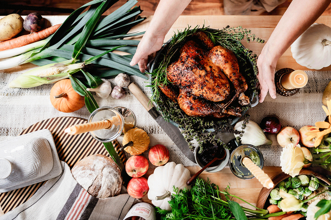 St. Norbert Farmers' Market Thanksgiving Farm-to-Table Oven Roasted Chicken. Table with roasted chicken and colourful fall harvest vegetables